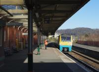 Sunshine on Llandudno Junction on 14th April 2015, as the 1735 Holyhead - Cardiff Central is despatched.<br><br>[Colin McDonald //]