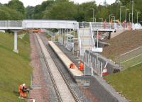 Various activities taking place in and around the new Eskbank station on 3 June 2015. Looking north towards the site of the original 1847 station lying approximately half a mile away. The sign reads <I>'Eskbank Alight here for the bus link to Dalkeith Country Park.'</I> <br><br>[John Furnevel 03/06/2015]