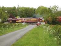 DB palindromic numbered 66066 opens up as it crosses Betteras Hill Road level crossing heading south shortly after leaving Milford Junction sidings on 18 May with a mixed rake of refurbished DB red and un-refurbished ex National Power bogie coal wagons.<br><br>[David Pesterfield 18/05/2015]