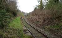 This disused section of the platform at Minffordd continues on the south side of the overbridge carrying the road and the Ffestiniog line over the Cambrian coast line. Photographed in April 2015. [Ref query 4710]<br><br>[Colin McDonald 13/04/2015]