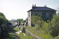 The 1865 station at Pampisford (which carried the name Abington until 1875) was the last on the Stour Valley line before it connected with the London-Cambridge line at Great Shelford. This is a westward view on 22nd May 1977, when it was in use as a builder's yard some 10 years after final closure. All trace of the building was later swept away as part of an A11 road improvement scheme.<br><br>[Mark Dufton 22/05/1977]