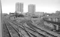 Looking back from a passing southbound train on the ECML towards Riverside Junction and the platforms of the closed Byker Station in the summer of 1985. The Riverside Branch was closed to passengers on 23 July 1973 but this end of the loop was retained to serve an industrial customer until 1988. [Ref query 4733] <br><br>[Bill Roberton 13/07/1985]