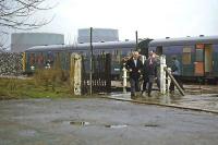 Gasometers, piles of refuse, a decrepit station, potholes in the road and cold drizzle greet passengers alighting from a shabby DMU at St Albans Abbey on 29th December 1978. If the post Christmas gloom was not enough, there was also the ongoing Winter of Discontent to reflect upon. 'Can things get any worse?' the downcast folk in the photo might be wondering. Many decades later, social historians have still to agree on an answer..<br><br>[Mark Dufton 29/12/1978]