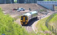 Hottest day of the year so far as a Tweedbank - Newcraighall driver training trip approaches its destination on 10 June 2015. The 158 has just passed the recently constructed Millerhill food waste recycling plant and cleared the points at the end of the double track section from King's Gate.<br><br>[John Furnevel 10/06/2015]