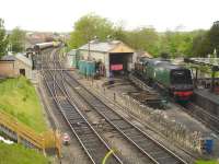 Looking north from Northbrook Road overbridge, Swanage, on 13 May with Bullied BB Class 34070 <I>Manston</I> stabled by the coaling stage. Diesel Shunter D3591 is on the left of the running line in the middle distance, whilst an Hymek and another diesel loco can be seen in the background.<br><br>[David Pesterfield 13/05/2015]