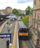 The driver of a Neilston service check the doors while one of his customers humps his bike up the stairs to Victoria Road. I imagine it's space restraints on the island platforms of the Cathcart lines that mean that lifts and ramps are not (yet?) a feature.<br><br>[David Panton 30/05/2015]