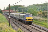 The <I>Highland Sleeper</I> passing Woodacre on 12th June 2015 heading south behind DBS 90021. The train was running 115 minutes late at this point, resulting in a rare opportunity to photograph the sleeper passing through Lancashire in daylight. <br><br>[Mark Bartlett 12/06/2015]