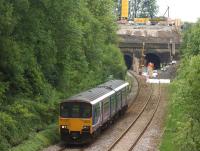 Northern 150115 heads south from Farnworth Tunnel on 2 June as work continues in connection with electrification of the route. The Clitheroe to Manchester Victoria service is running wrong line due to current closure of the larger tunnel, normally used by up trains.<br><br>[John McIntyre 02/06/2015]