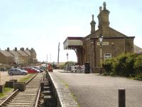 Looking south towards the buffer stops along the former terminus at West Bay, at the end of the short lived extension south from Bridport on the branch line from Maiden Newton. In May 2015 the building houses 'The Station Cafe', with a length of track still running the full length of the platform.<br><br>[David Pesterfield 12/05/2015]