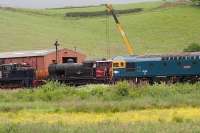 BRCW 33102 about to take a train past stock undergoing maintenance at Cheddleton on the heritage Churnet Valley Railway  on 17 June 2015.<br><br>[John Thorn 17/06/2015]