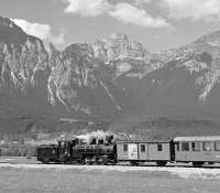 Against an impressive backdrop of the Rofangebirge, Zillertalbahn No. 4 rolls away from Strass im Zillertal towards Jenbach on the early afternoon steam working from Mayrhofen. At that time, two daily return services were being run during the peak season but this has now been reduced to one, rather limiting the photographic possibilities on the line. The remaining return working now takes place in the late afternoon so that the lighting is no longer optimal for this shot.<br><br>[Bill Jamieson 05/09/2005]