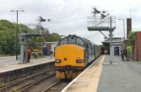 Newly arrived at Barrow-in-Furness, DRS 37218 is signalled into the carriage sidings with its empty stock and trailing loco. The train had earlier worked down from Carlisle to Preston then back here to lay over for three hours before making a return trip to Carlisle.<br><br>[Mark Bartlett 22/06/2015]