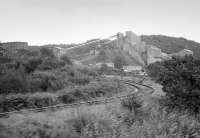 View from a passing train of Hillhouse Quarry and its branch line off the Kilmarnock and Troon, on 31 August 1985. [Ref query 5336]<br><br>[Bill Roberton 31/08/1985]
