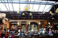 Inside Durham Gilesgate Station in May 2015. Architect G T Andrews would perhaps approve of the restoration work. Leaning on (and around) the bar are distinguished members of the North Eastern Railway Association, engaged in ernest historical research. (The management and staff of the restaurant were very welcoming and tolerant of the visiting eccentrics, notwithstanding that they were about to cater for a large wedding party.)<br><br>[Brian Taylor 02/05/2015]