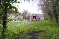 View west along the embankment of the line into the terminus at Durham Elvet in May 2015. The building is the Clubhouse of Durham RFC, built on the site of the station throat. Elvet was Durham's fourth station, opened in 1893 when the NER extended the branch into (just) the city. The site of the station buildings is now occupied by the Magistrates court. Passenger services were short-lived with withdrawal in Jan 1931. However on one day per year, until final closure in 1954 the station was one of Britain's busiest. This was the annual Durham Miners Gala when excursions ran from many of the county's pit villages to Elvet, emptying onto the racecourse. Attendance at the Gala in its heyday would be 150,000 plus (city population 20,000!).<br><br>[Brian Taylor 02/05/2015]