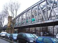 A Bombardier & Alstom built MF2000 (MF01) EMU runs east across the substantial girder bridge along Boulevard de la Chapelle on 26 February, shortly after leaving La Chapelle station on the elevated Paris Metro Line 2 [see image 50492]. This is a case of rail over road over rail, as below the road, running left to right, are the approach tracks running into Gare de l'Est station located a short distance to the right.<br><br>[David Pesterfield 26/02/2015]