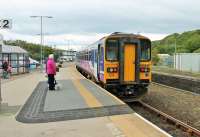 The doors close on a Lancaster to Carlisle service, formed of two <I>Sprinter Bubble Cars</I>, standing alongside the <I>Harrington Hump</I> on the through line at Whitehaven. Harrington, where the prototype raised section of platform was first installed, is less than four miles north of Whitehaven. A further hump is situated near the buffers on Whitehaven's bay platform. <br><br>[Mark Bartlett 22/06/2015]