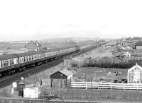 A Brush Type 4 takes the 10.55 Stranraer Harbour - London Euston north through Falkland Junction on 17 April 1983. [Ref query 7154]  <br><br>[John Furnevel 17/04/1983]