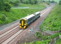 Site of Tynehead station (1848-1969) looking south from the road bridge in June 2015 with a 158 on crew training duty passing through. Note the Network Rail access points created on both sides of the line - these follow the route to the former goods yard on the up side and the platform steps on the down side. [See image 42698]<br><br>[John Furnevel 26/06/2015]