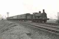 Dawsholm shed's ex-Caledonian <I>'Jumbo'</I> 0-6-0 no 57472 approaching Scotstoun East station on 9 August 1957 with a Rutherglen - Balloch train<br><br>[G H Robin collection by courtesy of the Mitchell Library, Glasgow 09/08/1957]