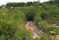 The scene at the Linlithgow end of Winchburgh tunnel on 2nd July 2015 with the lowering of the track level in progress. On the right are the now-flooded claypits of the former brickworks.<br><br>[Colin McDonald 02/07/2015]