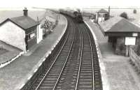 Hurlford shed's Standard Mogul 77016 passing through Drybridge station on 3 August 1958 with a Sunday Ayr to Kilmarnock train. [Ref query 13886]   <br><br>[G H Robin collection by courtesy of the Mitchell Library, Glasgow 03/08/1958]