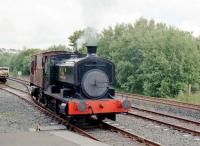 No.10 giving rides in the converted brake van at ARPG Dunaskin on 26 June 2015. The nearer two lines belong to ARPG while the Network Rail line to Dalrymple Junction is beyond. It has seen no coal traffic for about three years and is currently 'out of use'. Beyond the 10 mph speed limit sign the 'main line' up to the unused Chalmerston Opencast belongs to Hargreaves as successors to Scottish Coal.<br><br>[Colin Miller 26/06/2015]