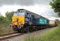 <I>You just never know what will be on the Heysham flasks</I>. A very shiny DRS 57301 <I>Goliath</I> eases onto the Heysham branch at Torrisholme Junction behind EE Type 1 20305 and a single flask wagon. New to Canton in 1965 as D1653 it has enjoyed a varied 50 year career, and prior to being leased by DRS was Virgin Thunderbird <I>Scott Tracy</I>. <br><br>[Mark Bartlett 08/07/2015]