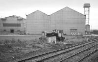 BSC Gartcosh, seen from a passing train on 31 August 1985.  A battered Ruston Hornsby diesel locomotive lies in the foreground. <br><br>[Bill Roberton 31/08/1985]