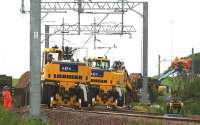 View from just beyond Bargeddie station on 11 July, showing road/rail vehicles in use by contractors preparing to remove the track. This was the first day of the 2 week line closure for the installation of the new viaduct. <br><br>[Colin McDonald 11/07/2015]