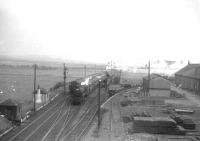 Trains passing on the WCML just south of the former Strawfrank Junction on 29 June 1963. The northbound train is hauled by Carstairs based Black 5 no 45173.<br><br>[John Robin 29/06/1963]