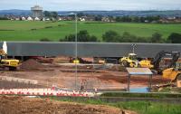 View south towards the centre of the new bridge on 12th July 2015. The OHLE, track work and ballast have been removed and there is a clear view through to the steelwork of the structure. The top of one of the central supporting columns [see image 50878] can be seen in the fenced off area to the right of centre of the picture.<br><br>[Colin McDonald 12/07/2015]