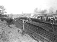 General view over Largs station on 27 February 1954, as Fowler 2P 4-4-0 no 40608 prepares to get underway with a train for Glasgow St Enoch. <I>Editor's footnote</I>: Additional info from Colin Miller points out on the far right <I>The Old Engine</I>, a stationary boiler that was probably from an old 0-6-0 and mounted on a brick base with timber hut attached for the fireman. It is actually steaming in this picture, supplying heat for the rake of coaches. Its predecessor was a G&SW 4-6-4T. Any photos of the Largs stationary boilers would be welcomed for Railscot publication. <br>
<br><br>[G H Robin collection by courtesy of the Mitchell Library, Glasgow 27/02/1954]