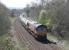 A train of cement empties from the Hanson siding at Avonmouth is on the last mile of a long journey on 18th April. DBS 66023 is approaching Clitheroe station and the nearby Ribble cement plant at Horrocksford where it will be loaded. [See image 42683]<br><br>[Mark Bartlett 18/04/2015]
