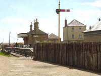 Looking seaward to the former West Bay station south of Bridport, showing the sleeper wall erected along the approach track-bed and the departure home signal that stands guard north of the station. West Bay saw its last rail passengers in September 1930.<br><br>[David Pesterfield 12/05/2015]