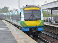 Borders Railway liveried 170414 brings up the rear of a Dundee - Edinburgh service at a wet Dalmeny on 19 July.<br><br>[Bill Roberton 19/07/2015]