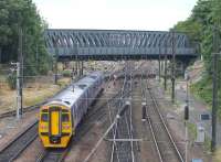 Nearing the end of a three hour journey that started at Blackpool North, a Northern service slows for York. 158757 is just about to pass under the distinctive bridge with Holgate Junction, for the station avoiding line, directly in front of the train. <br><br>[Mark Bartlett 18/07/2015]