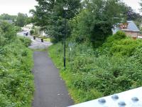 Looking east from Bracklin Road bridge along the course of the Callander & Oban railway on 21 July 2015.  To the right, beyond the new house, was the site of Callander (Old) Station, later a goods yard.<br><br>[Bill Roberton 21/07/2015]
