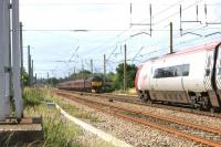 WCRC 47760 heads south at Balshaw Lane Junction with an ecs move from Carnforth to Crewe as a Virgin Pendolino thunders northwards on 17 July 2015.<br><br>[John McIntyre 17/07/2015]