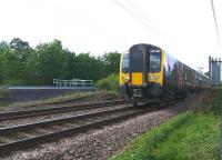 A TransPennine Class 350 EMU heads south on the WCML past the site of the former Coppull station on the evening of 17 July 2015. At this location there used to be 4 tracks with an underpass linking the platforms. To the left of the EMU the remains of the stairs down to the passageway can be seen from what would have been the middle platform.<br><br>[John McIntyre 17/07/2015]