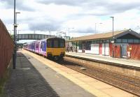 Scene at Horwich Parkway looking north on 17 July 2015, with a Hazel Grove to Preston service arriving.<br><br>[John McIntyre 17/07/2015]