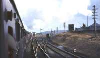 View from a carriage window on board <I>Scottish Rambler No 3</I> approaching Beattock summit on 29 March 1964 behind ex-LMS <I>Crab</I> no 42737. Note the coach used by the <I>'siege train'</I> standing alongside the private platform on the right [see image 21751].<br><br>[John Robin 29/03/1964]
