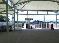 A passenger hurries towards a departing tram at Ednburgh Airport terminus in July 2015.<br>
<br><br>[David Panton 23/07/2015]