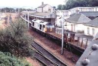 The old Carstairs station looking in a sorry state in August 1997 as an up freight hauled by Transrail liveried 60058 <I>John Howard</I> passes through. Demolition got underway shortly thereafter with a view to making the station <I>'...fit for the new millennium'</I> [see image 2156].<br><br>[John Furnevel 19/08/1997]