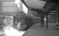 The 9.25am Crewe - Perth stands at Carlisle platform 3 on 25 April 1964 behind Upperby Royal Scot 46123 <I>Royal Irish Fusilier</I>. The Scot will take the train north after relieving Stanier Pacific no 46248 <I>City of Leeds</I> which brought the train north from Crewe. [See image 33782]<br><br>[K A Gray 25/04/1964]
