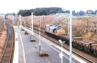 An engineer's train heads north through Carstairs station after leaving the up sidings on 4 July 1997. The locomotive is 'Transrail' liveried 37221.<br><br>[John Furnevel 04/07/1997]