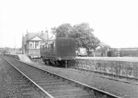 Scene at Inverugie, Aberdeenshire, first station out of Peterhead, on 4 July 1951. View is west towards Maud Junction with an unidentified coach standing in the bay platform. [Ref query 38055] <br><br>[G H Robin collection by courtesy of the Mitchell Library, Glasgow 04/07/1951]