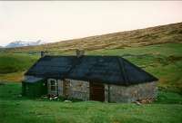 The shepherd's cottage at Gorton where, in 1889, Charles Forman, James Bulloch, J.E. Harrison, John Bett, Major Martin and N.B. McKenzie were to take shelter after the party walking the route of the prospective West Highland Railway got into difficulties. The cottage is now a bothy. The rising ground to the right is Meall a Ghortain, the name being adopted for both the cottage and station.<br><br>[Ewan Crawford //1994]