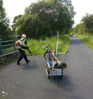 This gentleman was doing a fine job of maintaining the cyclepath parallel to the Glasgow to Ayr line on 15th July. Despite being laden with a trailer and a petrol engine powered leaf blower, he overtook my wife and I twice! Mobile Works indeed. View south towards Kilbarchan station.<br><br>[Ken Strachan 15/07/2015]