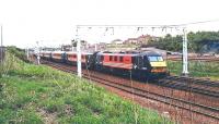 A Virgin Trains London Euston - Glasgow Central service runs north through Carstairs on a wet and windy 6 September 2002 hauled by 90002. In 1998 this locomotive became the first to be turned out in Virgin Trains red and black livery. It was named <I>'Mission Impossible'</I> to launch the challenge of upgrading passenger services on the WCML.<br><br>[John Furnevel 06/09/2002]